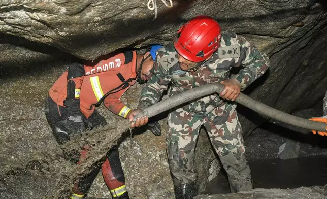 In this handout photograph provided by the Nepal Army, Nepalese soldiers undertake a search and rescue operation at the Chilime hydropower project following earlier flash floods in Nepal's Rasuwa district, Wednesday, Sept. 16, 2026. (Nepal Army via AP)