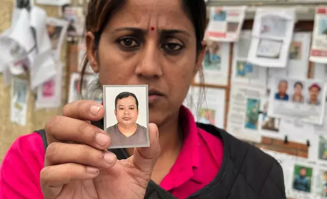 In this photo taken with a smartphone, Usha Khatri shows a photo of her husband Indra Bahadur who has been missing since last month's flood outside Tribhuvan University Teaching Hospital, in Kathmandu, Nepal, Thursday, Sept. 17, 2026. (AP photo/Upendra Man Singh)