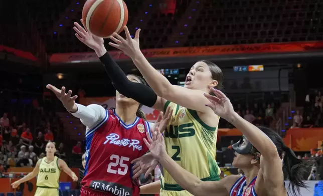 Puerto Rico's Denise Solís and Australia's Jade Melbourne rebaound during the Women's Basketball World Cup match between Australia and Puerto Rico in Berlin, Friday, Sept. 4, 2026. (AP Photo/Ebrahim Noroozi)
