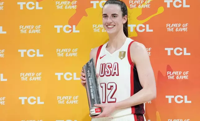 United States' Caitlin Clark holds the trophy for the player of the game during the Women's Basketball World Cup match between China and the United States in Berlin, Friday, Sept. 4, 2026. (AP Photo/Ebrahim Noroozi)