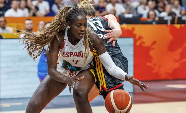 Spain's Awa Fam reaches for a ball against the defense of Germany's Leonie Fiebich during a Women's World Cup basketball game between Germany and Spain, in Berlin, Friday, Sept. 4, 2026. (Andreas Gora/dpa via AP)