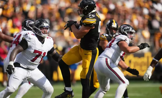 Pittsburgh Steelers outside linebacker T.J. Watt (90) intercepts a pass made by Atlanta Falcons quarterback Cooper Rush (13) during an NFL football game, Sunday, Sept. 13, 2026, in Pittsburgh. (AP Photo/Gene J. Puskar)