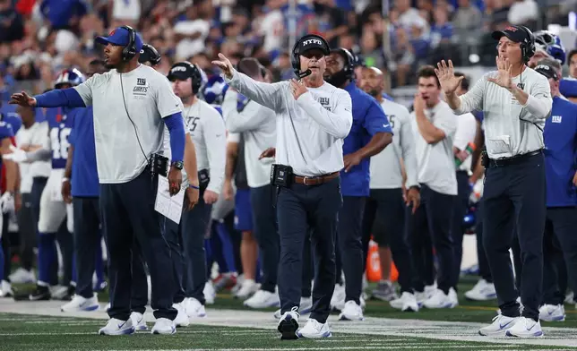 New York Giants head coach John Harbaugh, center, reacts during the first half of an NFL football game against the Dallas Cowboys, Sunday, Sept. 13, 2026, in East Rutherford, N.J. (AP Photo/Pamela Smith)