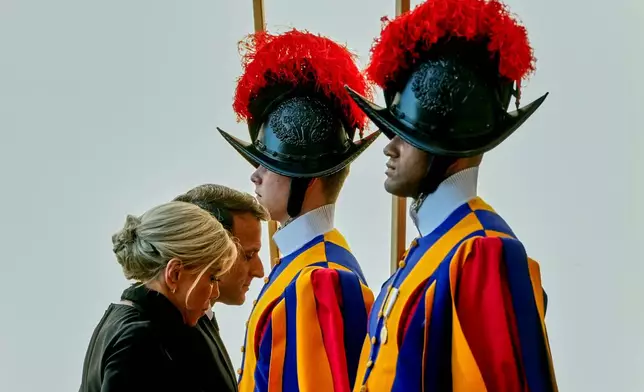 FILE - French President Emmanuel Macron and his wife Brigitte arrive in the St. Damasus Courtyard at the Vatican to meet with Pope Leo XIV, Friday, April 10, 2026. (AP Photo/Andrew Medichini, File)