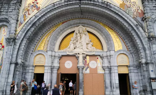 FILE - People enter the Notre-Dame-du-Rosaire basilica in Lourdes, southwestern France, Tuesday Sept. 8, 2026 . (AP Photo/Fred Scheiber, File)
