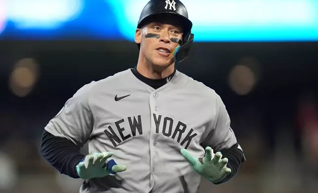 New York Yankees' Aaron Judge celebrates while running the bases after hitting a three-run home run during the eighth inning of a baseball game against the Minnesota Twins, Monday, Sept. 14, 2026, in Minneapolis. (AP Photo/Abbie Parr)