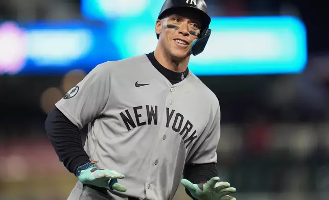 New York Yankees' Aaron Judge celebrates while running the bases after hitting a three-run home run during the eighth inning of a baseball game against the Minnesota Twins, Monday, Sept. 14, 2026, in Minneapolis. (AP Photo/Abbie Parr)