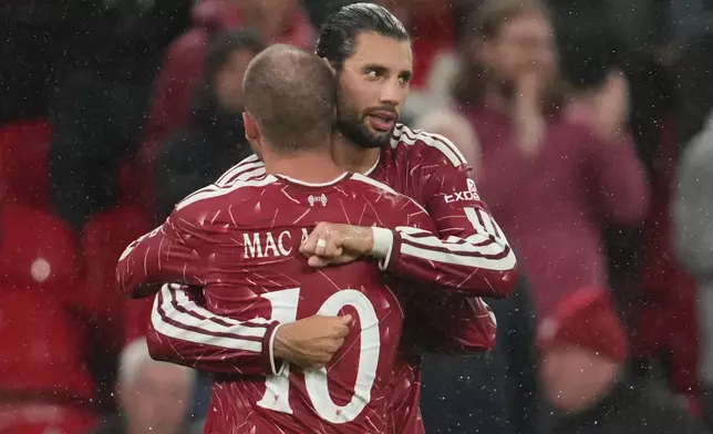 Liverpool's Alexis Mac Allister and Dominik Szoboszlai celebrate after the thrid goal during the third-round English Football League soccer match between Liverpool and Tottenham in Liverpool, England, Tuesday Sept. 15, 2026. (AP Photo/Jon Super)