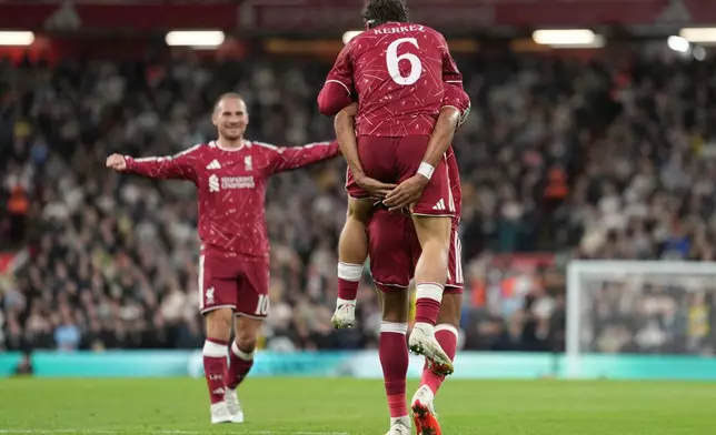 Liverpool players celebrate after a goal during the third-round English Football League soccer match between Liverpool and Tottenham in Liverpool, England, Tuesday Sept. 15, 2026. (AP Photo/Jon Super)
