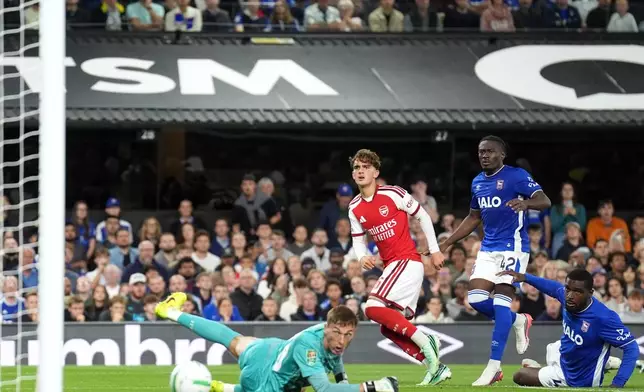 Arsenal's Max Dowman, centre, scores their side's third goal during the League Cup third round soccer match between Ipswich Town and Arsenal in Ipswich, England, Tuesday, Sept. 15, 2026. (Joe Giddens/PA via AP)