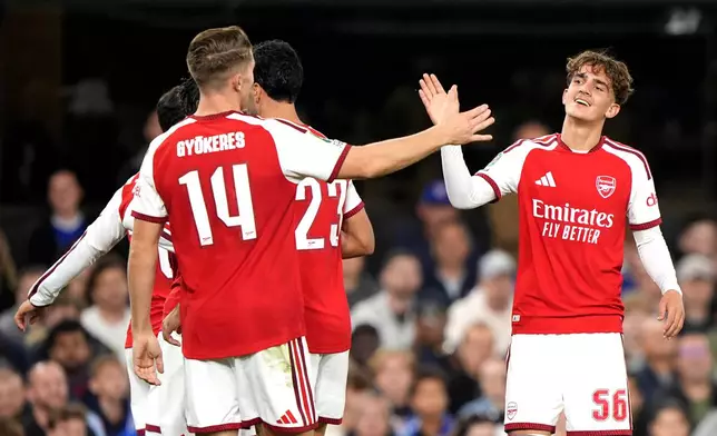 Arsenal's Max Dowman, right, celebrates scoring their side's third goal during the League Cup third round soccer match between Ipswich Town and Arsenal in Ipswich, England, Tuesday, Sept. 15, 2026. (Joe Giddens/PA via AP)