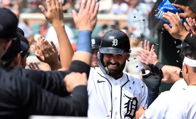 Detroit Tigers' Riley Greene, middle, is congratulated after hitting a two-run home run during the first inning of a baseball game against the Colorado Rockies, Sunday, Sept. 13, 2026, in Detroit. (AP Photo/Jose Juarez)
