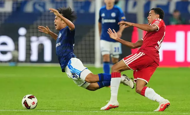 Bayern's Jamal Musiala, right, fouls Schalke's Satoshi Tanaka during the German Bundesliga soccer match between FC Schalke 04 and Bayern Munich in Gelsenkirchen, Germany, Saturday, Sept. 5, 2026. (AP Photo/Martin Meissner)