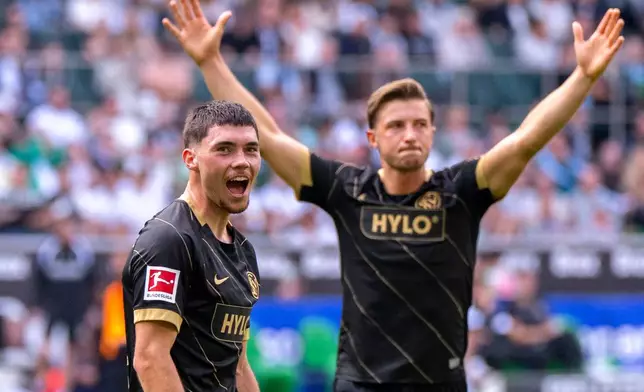 Elversberg's Felix Keidel, left, celebrates scoring with teammate Lukas Petkov during the Bundesliga soccer match between Borussia Mönchengladbach and SV Elversberg in Mönchengladbach, Germany, Saturday Sept. 5, 2026. (David Inderlied/dpa via AP)