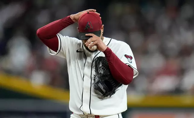 Arizona Diamondbacks starting pitcher Eduardo Rodriguez pauses on the pitcher's mound during the fifth inning of a baseball game against the Philadelphia Phillies, Tuesday, Sept. 1, 2026, in Phoenix. (AP Photo/Ross D. Franklin)