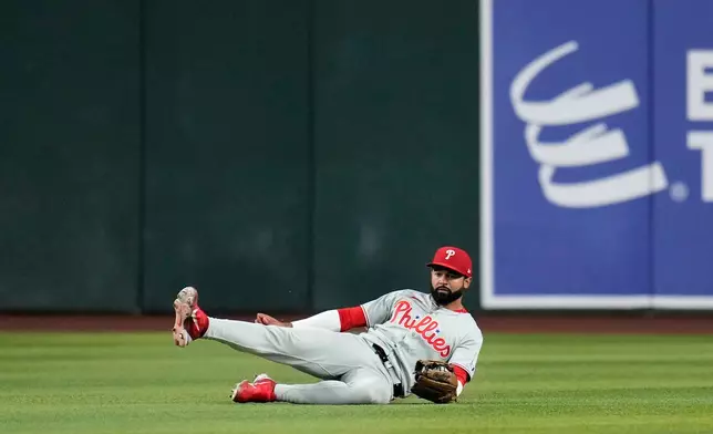 Philadelphia Phillies center fielder Derek Hill makes a diving catch on a line drive hit by Arizona Diamondbacks' Nolan Arenado during the fourth inning of a baseball game, Tuesday, Sept. 1, 2026, in Phoenix. (AP Photo/Ross D. Franklin)