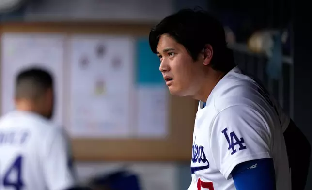 Los Angeles Dodgers' Shohei Ohtani watches from the dugout during the first inning of a baseball game against the Cincinnati Reds, Monday, Sept. 7, 2026, in Los Angeles. (AP Photo/Mark J. Terrill)