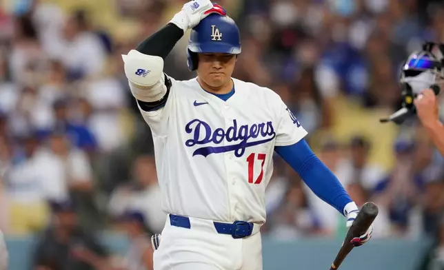 Los Angeles Dodgers' Shohei Ohtani walks back to the dugout after striking out as during the third inning of a baseball game against the Cincinnati Reds, Monday, Sept. 7, 2026, in Los Angeles. (AP Photo/Mark J. Terrill)
