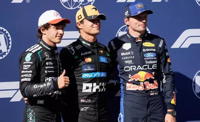 McLaren driver Lando Norris of Britain is flanked with Mercedes driver Andrea Kimi Antonelli of Italy, left, and Red Bull driver Max Verstappen of the Netherlands after the qualifying session for the Spanish Formula One Grand Prix in Madrid, Saturday, Sept. 12, 2026. (AP Photo/Bernat Armangue)
