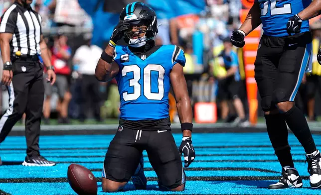 Carolina Panthers running back Chuba Hubbard (30) celebrates after scoring a touchdown during the second half of an NFL football game, Sunday, Sept. 13, 2026, in Charlotte, N.C. (AP Photo/Erik Verduzco)