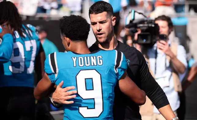Carolina Panthers head coach Dave Canales embraces quarterback Bryce Young (9) after an NFL football game, Sunday, Sept. 13, 2026, in Charlotte, N.C. (AP Photo/Scott Kinser)