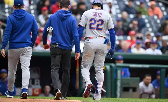 New York Mets' Juan Soto (22) walks back to the dugout after he was hit by a pitch by Washington Nationals pitcher Richard Lovelady during the ninth inning of a baseball game, Saturday, Sept. 26, 2026, in Washington. (AP Photo/Nick Wass)