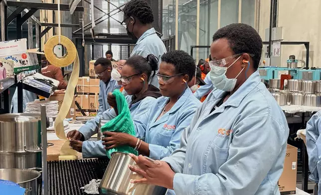 Workers assemble fuel-efficient cookstoves at BURN, a manufacturer of clean cooking appliances, in Kiambu, Kenya, on July 31, 2026. (AP Photo/Allan Olingo)