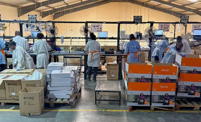 Workers assemble fuel-efficient cookstoves at BURN, a manufacturer of clean cooking appliances, in Kiambu, Kenya, on July 31, 2026. (AP Photo/Allan Olingo)