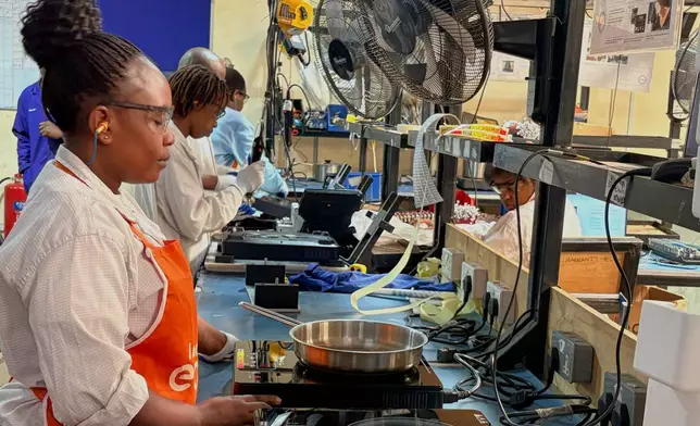 Workers assemble fuel-efficient cookstoves at BURN, a manufacturer of clean cooking appliances, in Kiambu, Kenya, on July 31, 2026. (AP Photo/Allan Olingo)