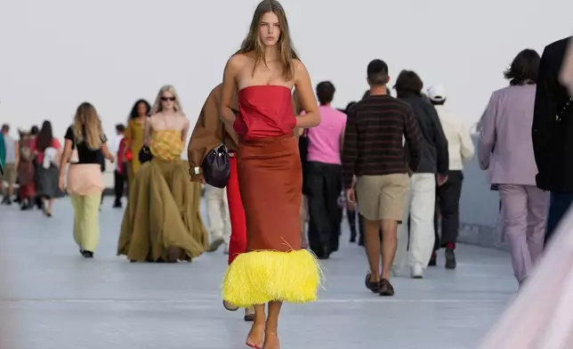 A model wears a creation part of the Moschino women's Spring-Summer 2027 collection, presented in Milan, Italy, Friday, Sept. 25, 2026. (AP Photo/Luca Bruno)