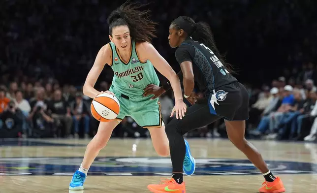 New York Liberty forward Breanna Stewart (30) dribbles downcourt as Minnesota Lynx guard Maya Caldwell (3) defends during the second half of a WNBA basketball game Friday, Sept. 18, 2026, in Minneapolis. (AP Photo/Abbie Parr)