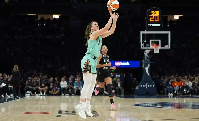New York Liberty guard Sabrina Ionescu, foreground, shoots during the second half of a WNBA basketball game against the Minnesota Lynx, Friday, Sept. 18, 2026, in Minneapolis. (AP Photo/Abbie Parr)