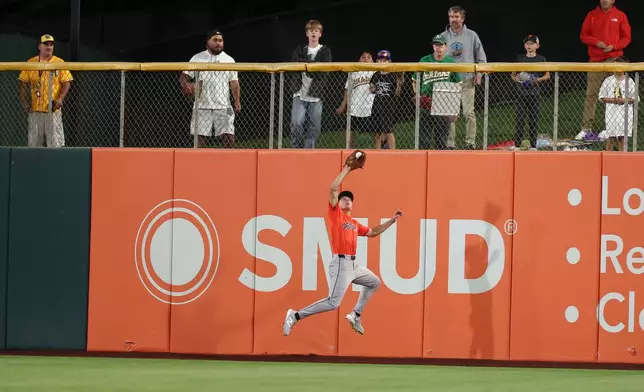 People watch as Houston Astros center fielder Lucas Spence catches a fly ball hit by Athletics' Tommy White during the fourth inning of a baseball game Friday, Sept. 25, 2026, in West Sacramento, Calif. (AP Photo/Sara Nevis)
