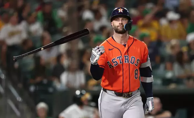 Houston Astros' Christian Walker flips the bat after hitting a home run during the fourth inning of a baseball game against the Athletics, Friday, Sept. 25, 2026, in West Sacramento, Calif. (AP Photo/Sara Nevis)