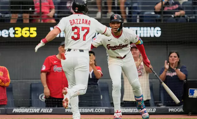 Cleveland Guardians' Travis Bazzana (37) is congratulated by Angel Genao, right, after hitting a home run in the first inning of a baseball game against the Chicago White Sox in Cleveland, Tuesday, Sept. 15, 2026. (AP Photo/Sue Ogrocki)