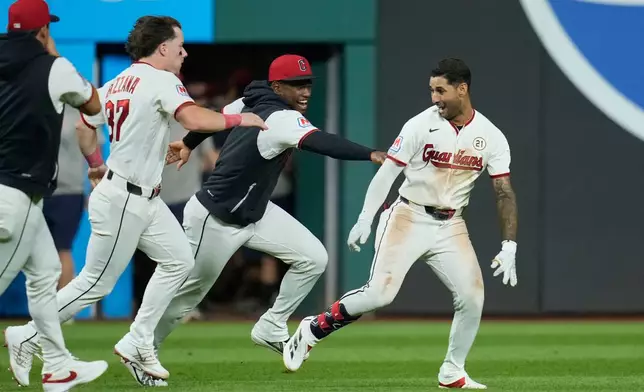 Cleveland Guardians' Brayan Rocchio, right, celebrates with teammates after hitting a game winning double in the ninth inning of a baseball game against the Chicago White Sox in Cleveland, Tuesday, Sept. 15, 2026. (AP Photo/Sue Ogrocki)