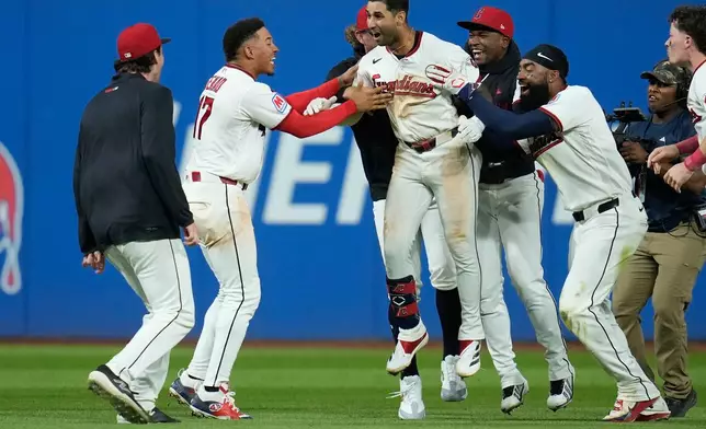 Cleveland Guardians' Brayan Rocchio, center, celebrates with teammates after hitting a game winning double in the ninth inning of a baseball game against the Chicago White Sox in Cleveland, Tuesday, Sept. 15, 2026. (AP Photo/Sue Ogrocki)