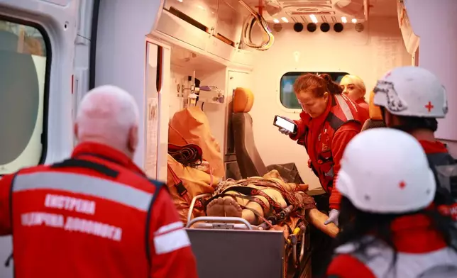 Medics inspect a body of a woman killed in a Russian strike on residential neighbourhood on Zaporizhzhia, Ukraine, on Saturday, Sept. 26, 2026. (AP Photo/Kateryna Klochko)