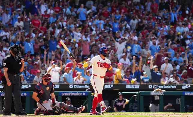 Philadelphia Phillies' Kyle Schwarber, right, watches his solo home run off Atlanta Braves pitcher Dylan Dodd during the seventh inning of a baseball game, Sunday, Sept. 6, 2026, in Philadelphia. (AP Photo/Derik Hamilton)