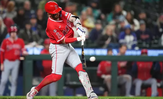 Los Angeles Angels' Zach Neto hits an RBI double against the Seattle Mariners during the ninth inning of a baseball game, Friday, Sept. 25, 2026, in Seattle. (AP Photo/Lindsey Wasson)