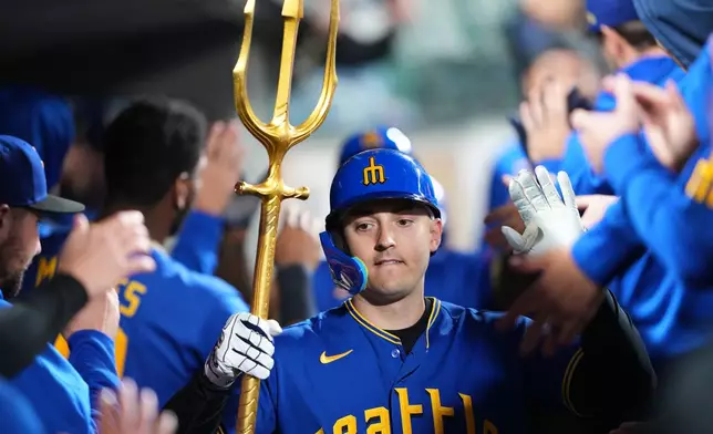 Seattle Mariners' Dominic Canzone celebrates hitting a two-run home run against the Los Angeles Angels during the ninth inning of a baseball game, Friday, Sept. 25, 2026, in Seattle. (AP Photo/Lindsey Wasson)