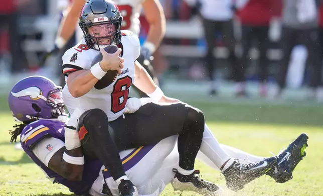 Tampa Bay Buccaneers quarterback Baker Mayfield (6) is sacked by Minnesota Vikings linebacker Dallas Turner (15) during the first half of an NFL football game in Tampa, Fla., Sunday, Sept. 27, 2026. (AP Photo/Chris O'Meara)