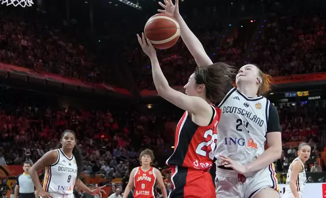 Germany's Lina Sontag blocks Japan's Kokoro Tanaka during the Women's Basketball World Cup match between Germany and Japan in Berlin, Saturday, Sept. 5, 2026. (AP Photo/Ebrahim Noroozi)