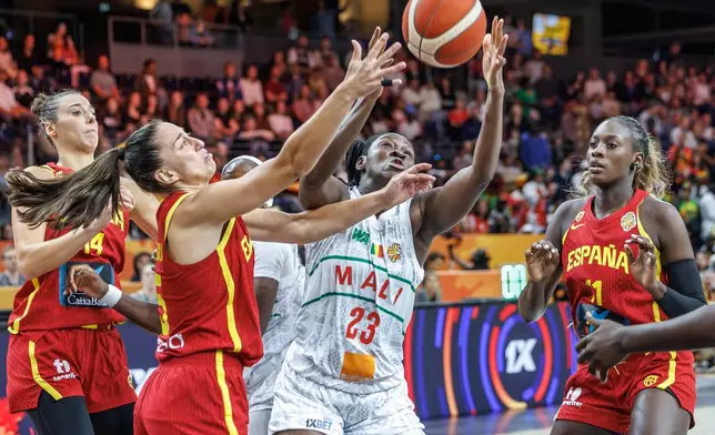 Mali's Sika Kone vies for the ball with Spain's Maite Cazorla, left, during the women's World Cup basketball match between Mali and Spain, in Berlin, Saturday, Sept. 5, 2026. (Andreas Gora/dpa via AP)