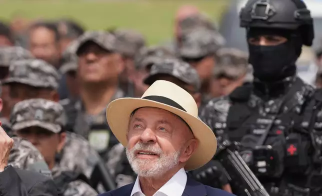 Brazilian President Luiz Inacio Lula da Silva poses for photos during a ceremony to announce a new security plan to combat organized crime in Rio de Janeiro, Friday, Sept. 18, 2026. (AP Photo/Silvia Izquierdo)