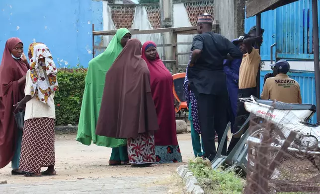 Families of miners who were arrested on suspicion of illegal mining and died in custody wait outside a hospital where their bodies are being held in Minna, Nigeria, Friday, Sept. 18, 2026. (AP Photo/Afolabi Sotunde)