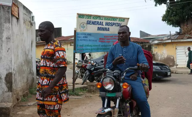 Families of miners who were arrested on suspicion of illegal mining and died in custody wait outside a hospital where their bodies are being held in Minna, Nigeria, Friday, Sept. 18, 2026. (AP Photo/Afolabi Sotunde)