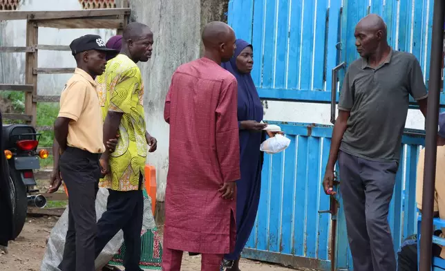 Families of miners who were arrested on suspicion of illegal mining and died in custody wait outside a hospital where their bodies are being held in Minna, Nigeria, Friday, Sept. 18, 2026. (AP Photo/Afolabi Sotunde)
