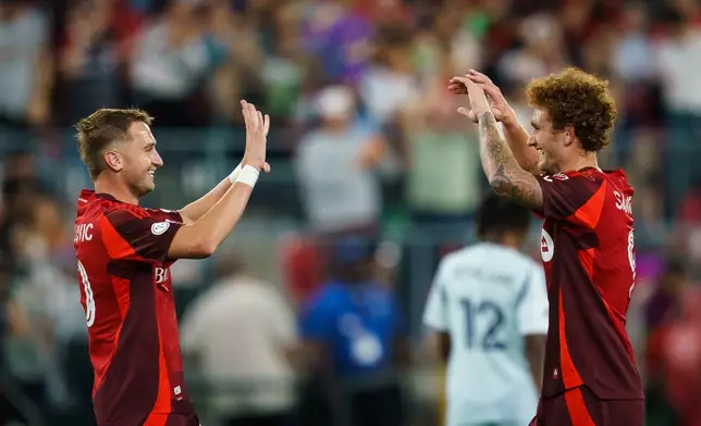 Toronto FC's Josh Sargent, left, celebrates his third goal against Chicago Fire FC with Djordje Mihailovic (10) during the second half of a soccer match in Toronto, Saturday, Sept. 5, 2026. (Keito Newman/The Canadian Press via AP)