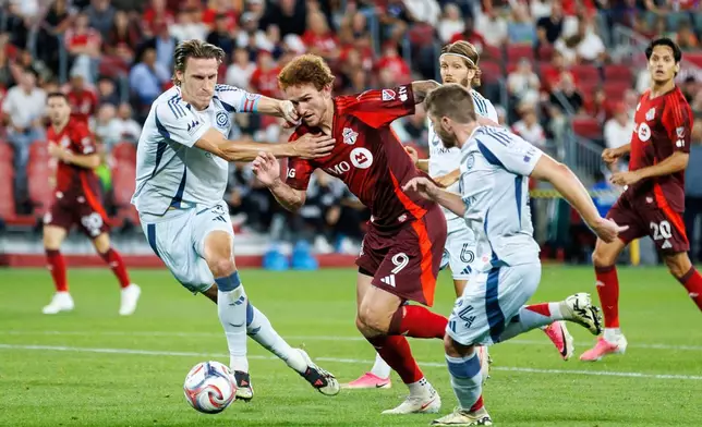 Toronto FC's Josh Sargent, centre, attempts to dribble past Chicago Fire FC's Jack Elliott (3), left, during the second half of a soccer match in Toronto, Saturday, Sept. 5, 2026. (Keito Newman/The Canadian Press via AP)